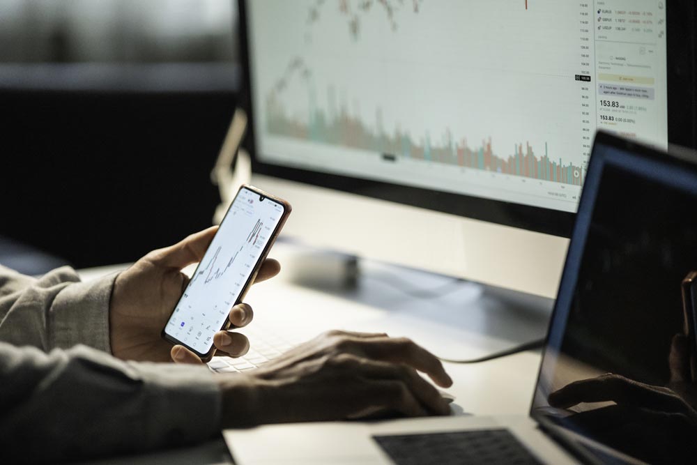 Trader studying stock markets on TradingView app at night